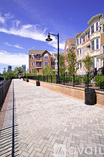 A brick walkway leads to apartment buildings.