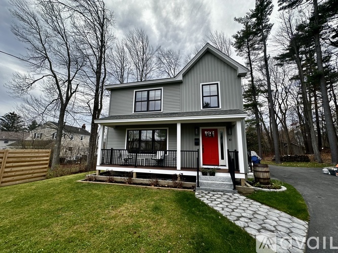 A house with a red door and a porch.