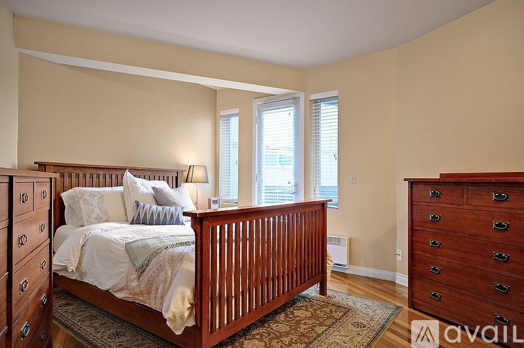 A bedroom with a large bed and a dresser.