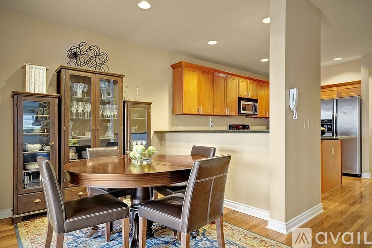 A dining room with a wooden table and chairs.