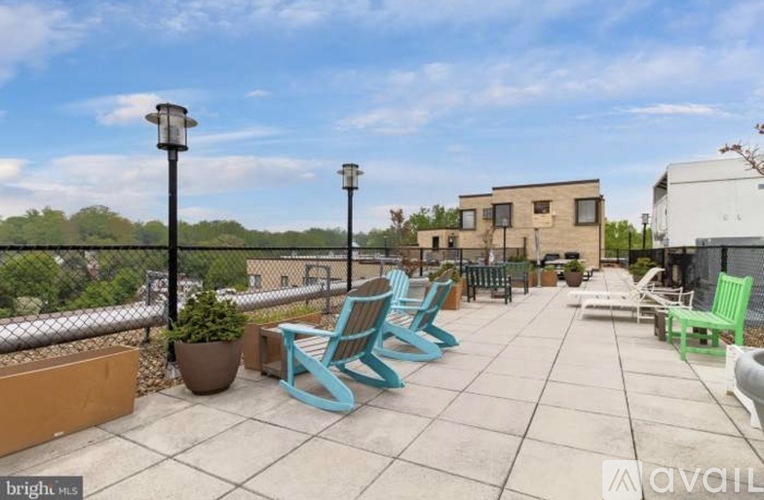 A patio with blue chairs and a lamp post.