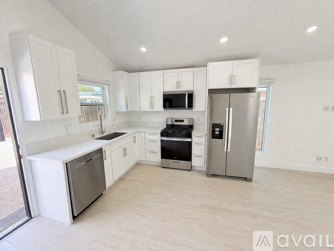 A kitchen with white cabinets and stainless steel appliances.