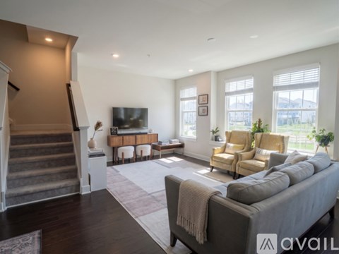 A living room with a grey couch and a television.