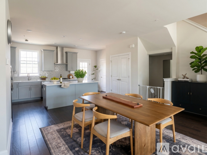 A modern kitchen with a dining table and chairs.