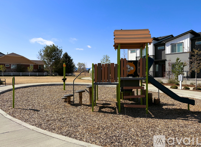 A playground with a wooden slide and a brown and green structure.