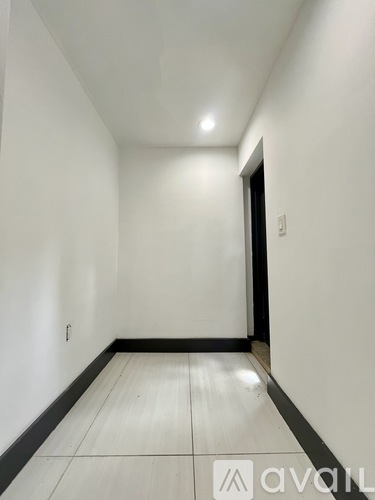 A long hallway with a door at the end.