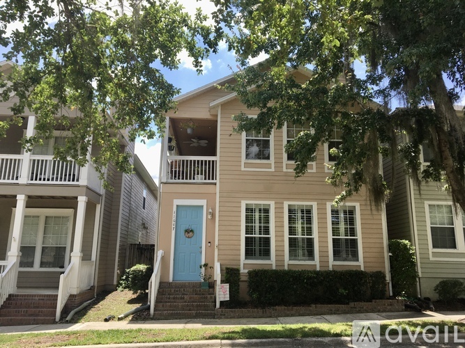 A two-story house with a blue front door.