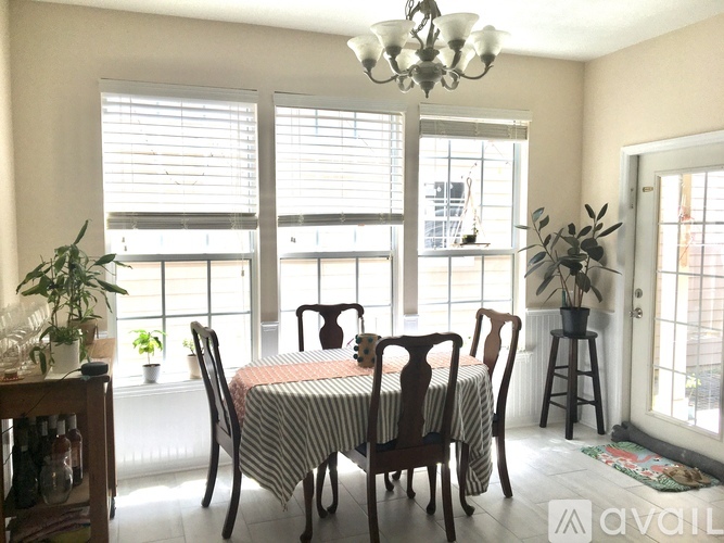 A dining room with a table set for six.