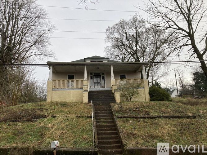 A house with a staircase leading to the front door.