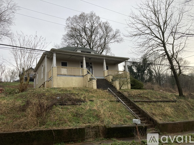 A house with a staircase leading to the front door.