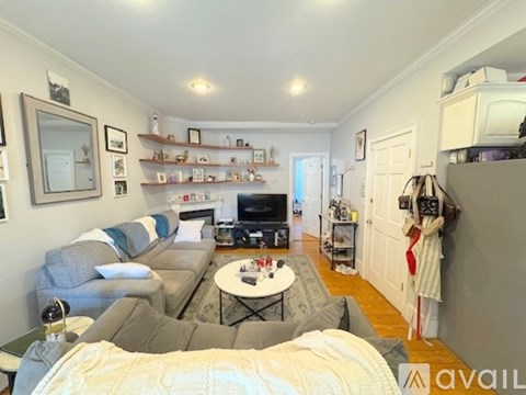 A living room with a grey couch and a white coffee table.
