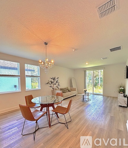 A dining room with a glass table and chairs.