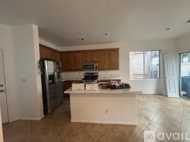 A kitchen with a white countertop and wooden cabinets.