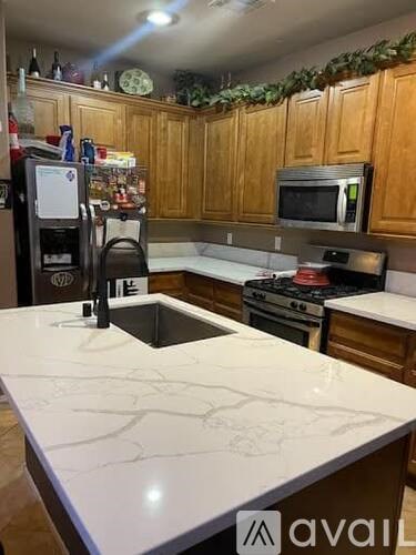 A kitchen with wooden cabinets and a white countertop.