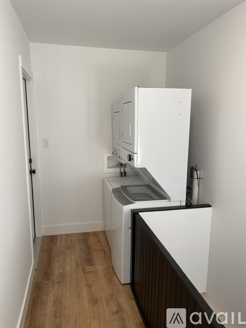 A small kitchen with a white fridge and a sink.
