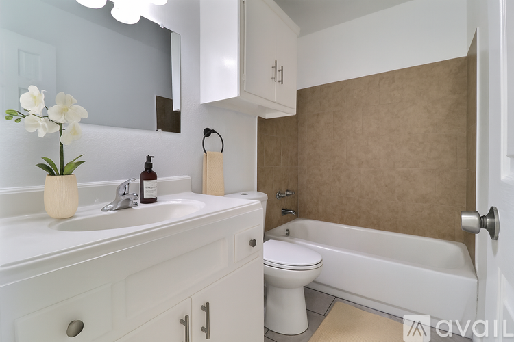 A white bathroom with a sink, toilet, and bathtub.