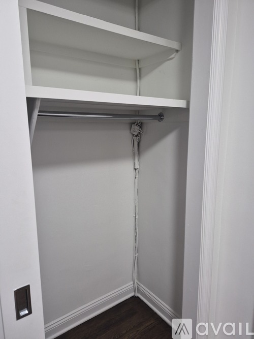 A white closet with a hanging rod.