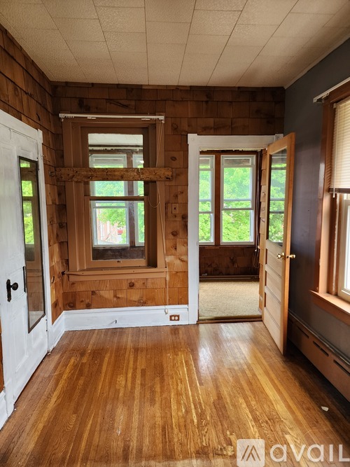 A room with wooden floors and a large window.