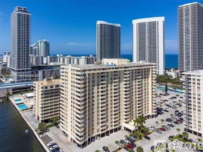 A view of a city with apartment buildings and a parking lot.