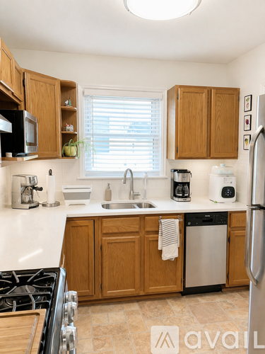 A kitchen with wooden cabinets and a white countertop.