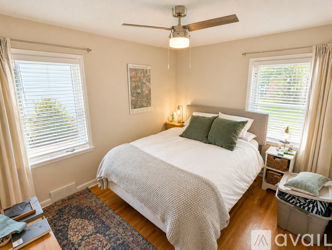 A bedroom with a large bed and a ceiling fan.