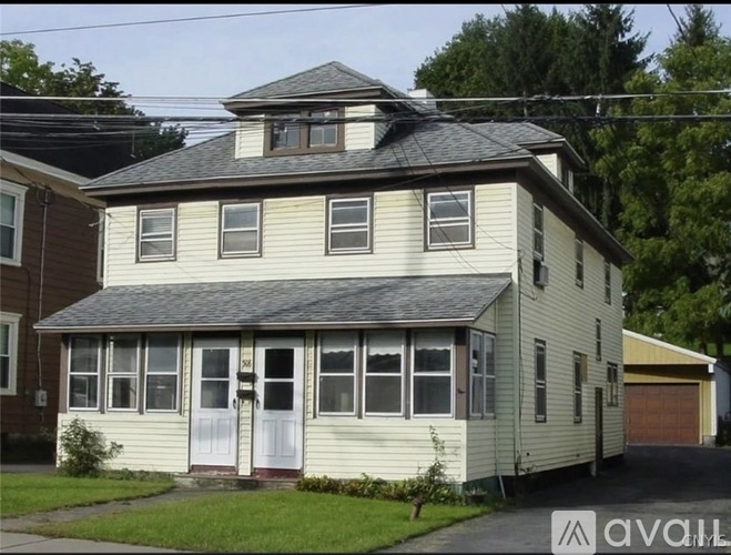 A two-story house with a garage is for sale.
