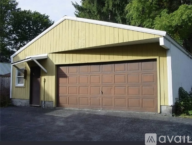 A yellow garage door is closed.