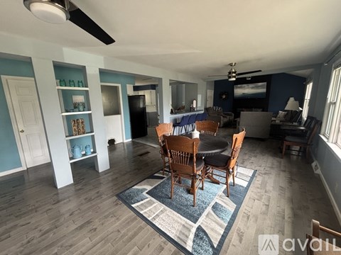 A living room with a dining table and chairs.