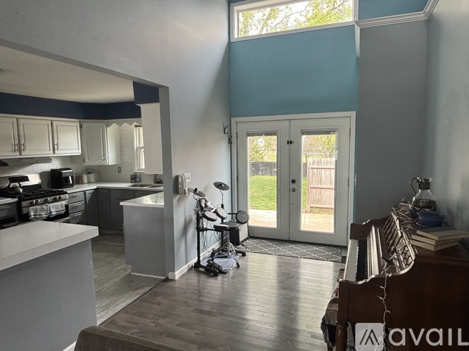A kitchen with a dining table and chairs in the foreground.