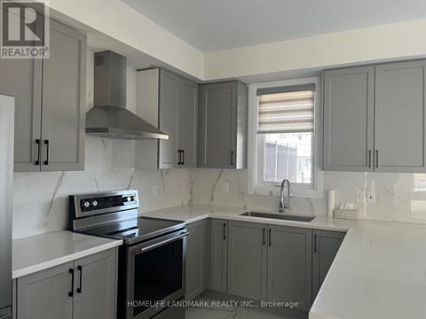 A kitchen with a stove top oven and a sink.