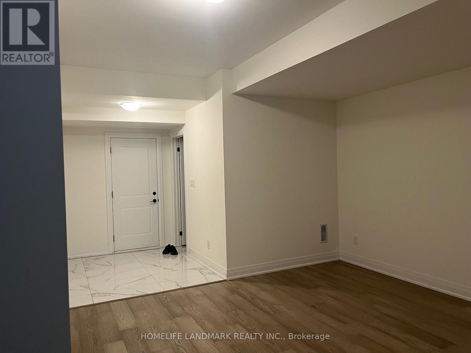 A room with a door and a wall with a logo that says REALTOR.