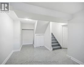 A room with a staircase and a door.