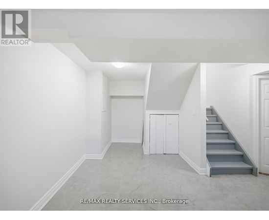 A room with a staircase leading to the second floor.