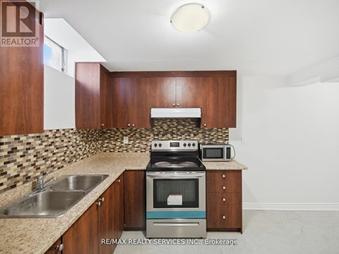 A kitchen with a stove top oven and microwave.
