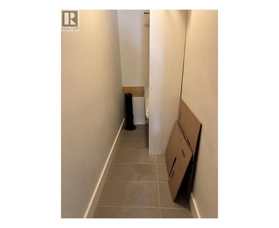 A hallway with a Realty logo on the wall.