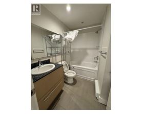 A bathroom with a sink, toilet, and bathtub.