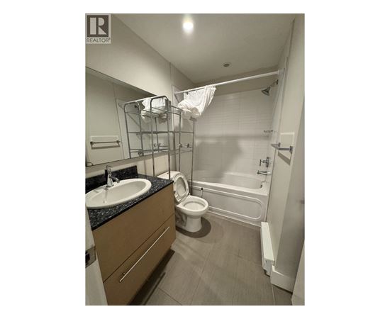 A bathroom with a sink, toilet, and bathtub.