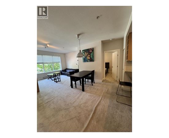 A living room with a dining table and chairs.