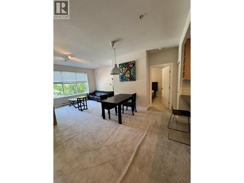 A living room with a dining table and chairs.