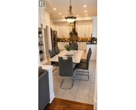 A modern kitchen with a dining table set for four.
