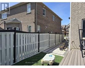 A house with a white picket fence and a hot tub in the yard.