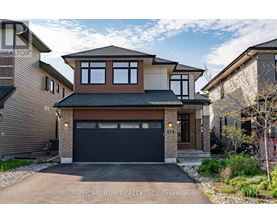 A two-story house with a garage is for sale.