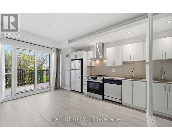 A modern kitchen with white cabinets and stainless steel appliances.