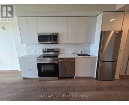 A kitchen with white cabinets and stainless steel appliances.