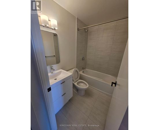 A white bathroom with a sink, toilet and bathtub.