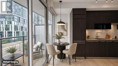 A modern kitchen with dark wood cabinets and a dining table with four chairs.