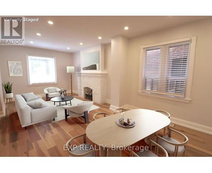 A living room with a fireplace and a dining table set for two.