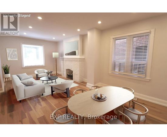 A living room with a fireplace and a dining table set for two.