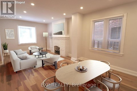 A living room with a fireplace and a dining table set for two.
