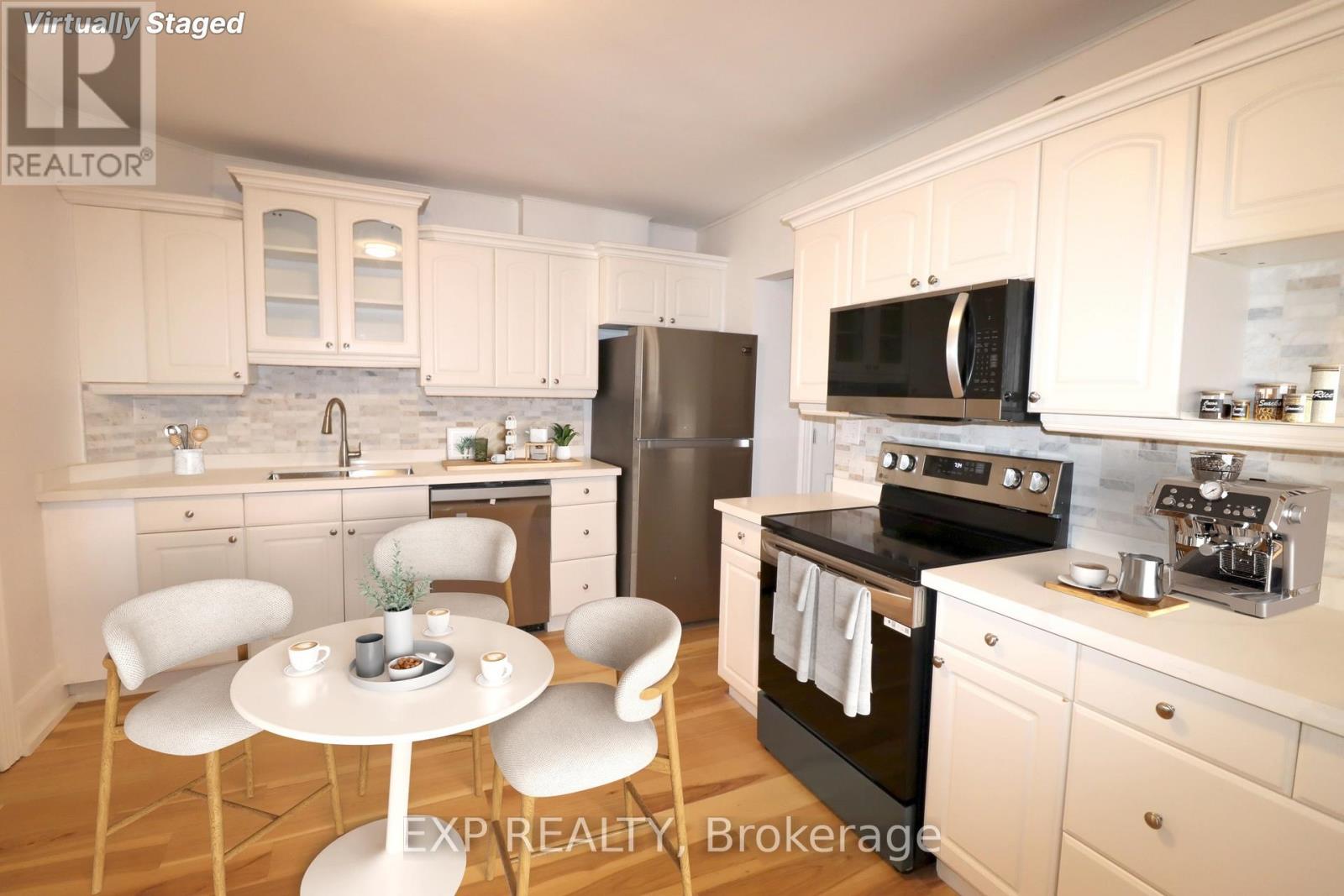 A kitchen with white cabinets and a black stove top oven.
